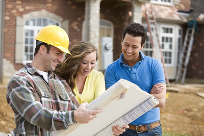 Young couple reviewing building plans of their dream home